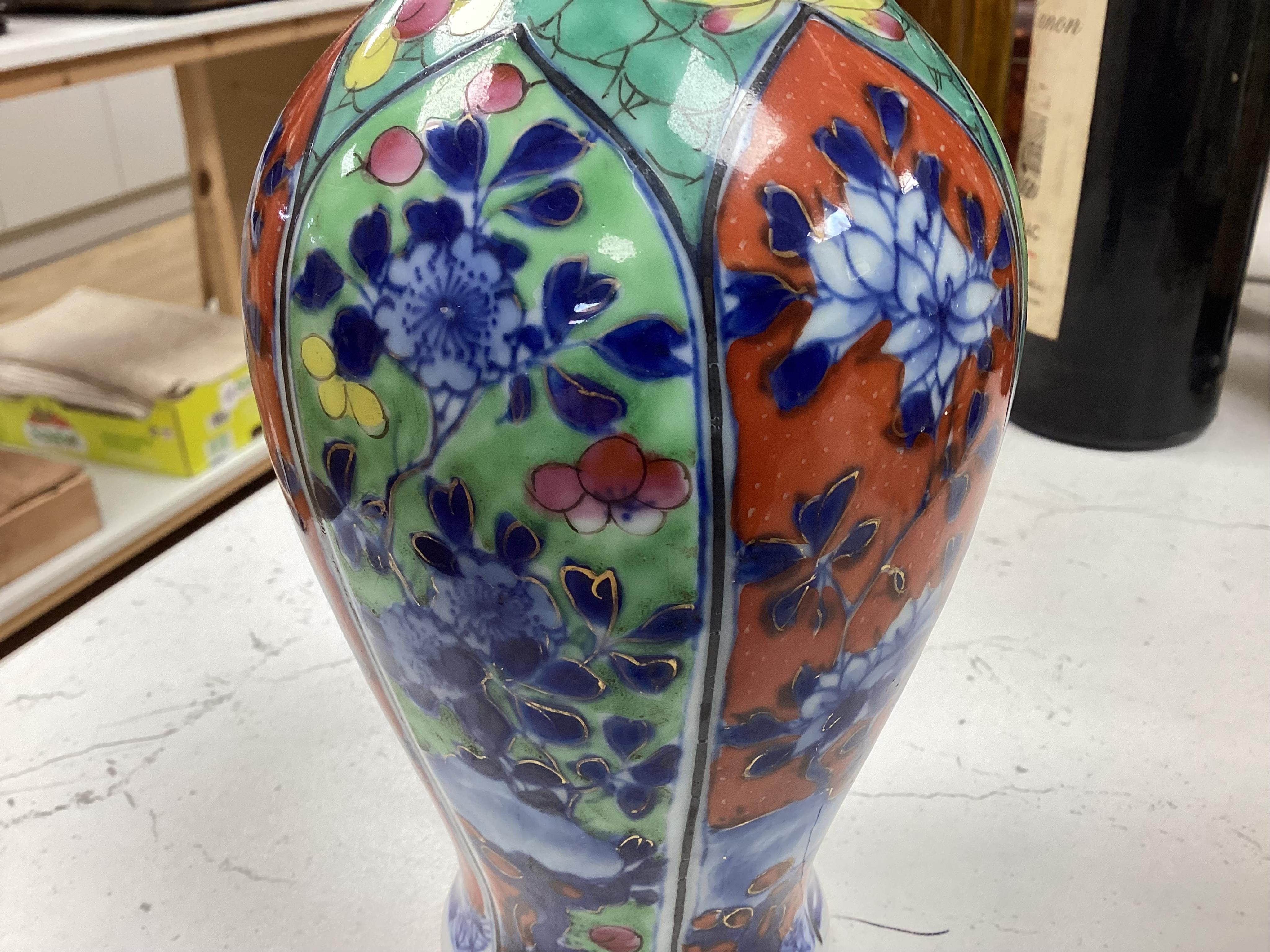 A Chinese clobbered blue and white bottle vase, Kangxi, 26cm high. Condition - ground off rim and hairline crack to neck